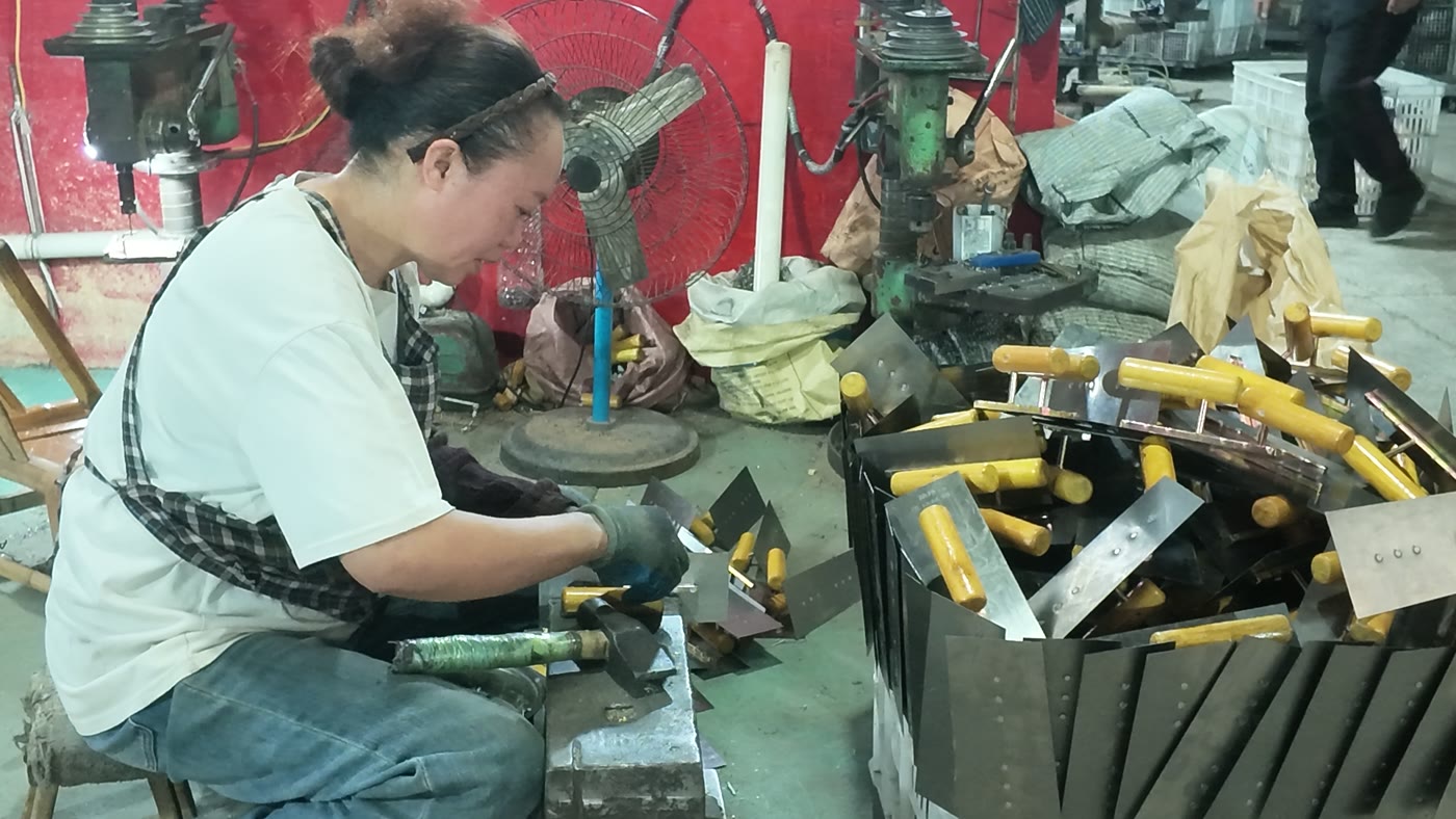 Worker assembling handles and blades